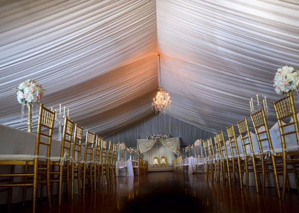 Numerous event rental products designed together for a beautiful white and gold wedding hall.